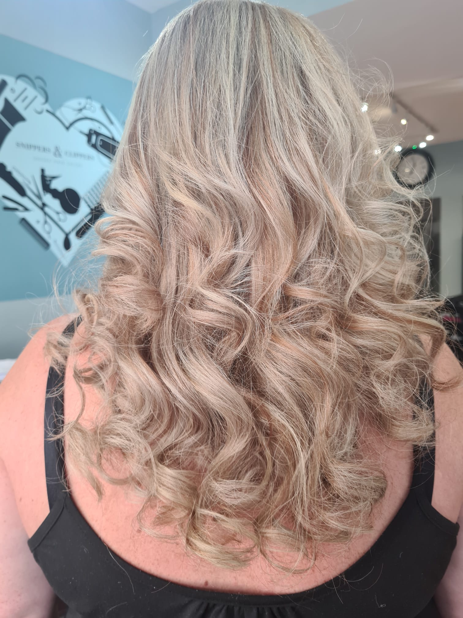 Ladies curly hair styled by snippers and clippers